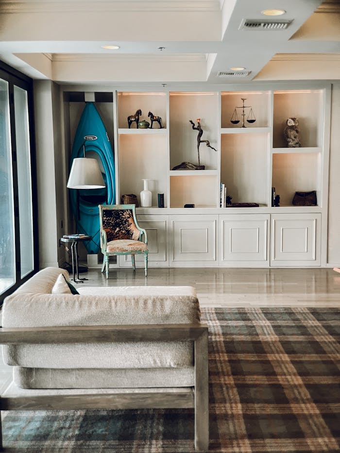 Stylish living room featuring contemporary shelving, decor items, and a kayak.